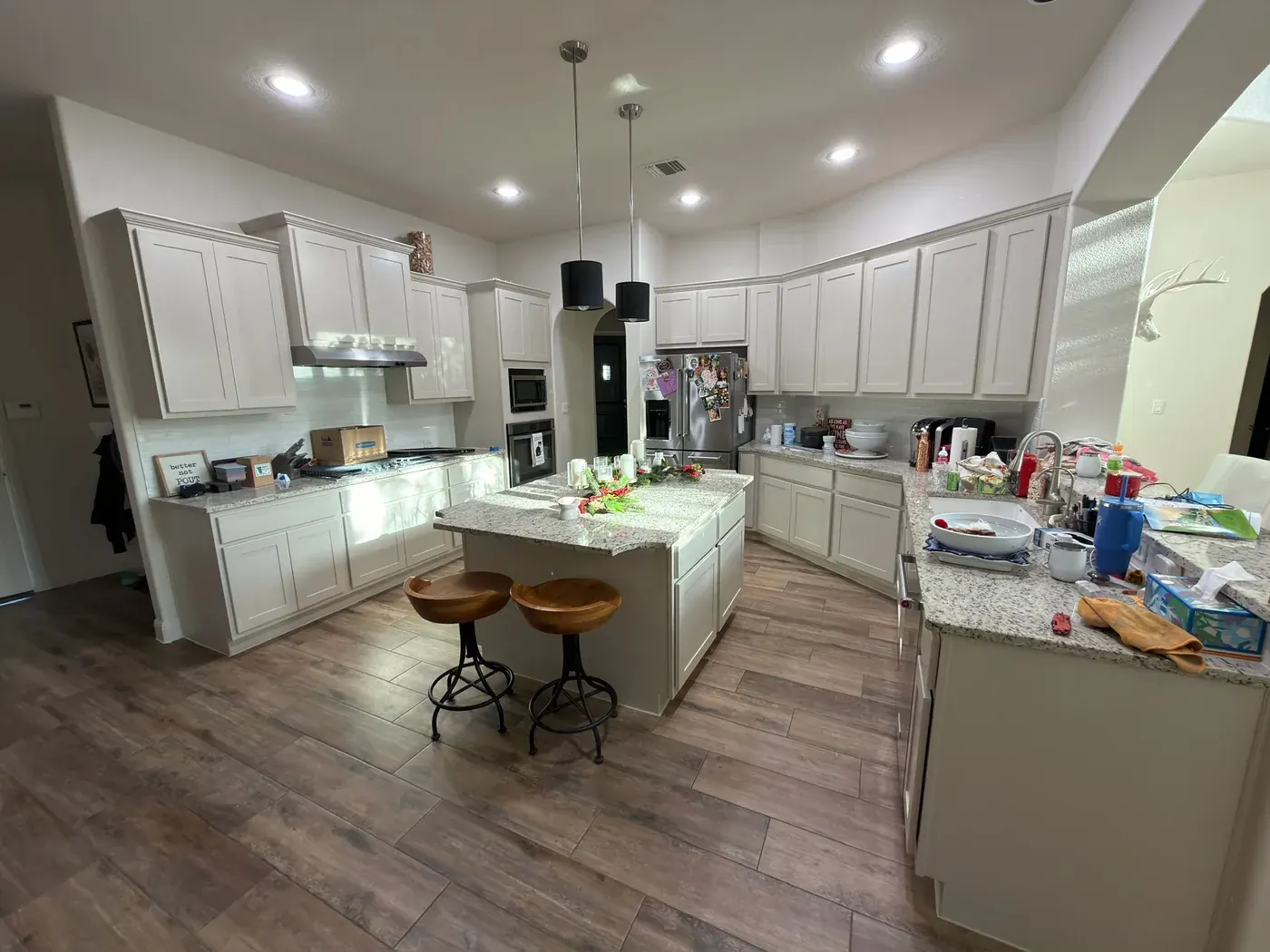 Kitchen cabinets after painting, bright white finish, crisp lines, clean job site by V&S Painting Austin TX
